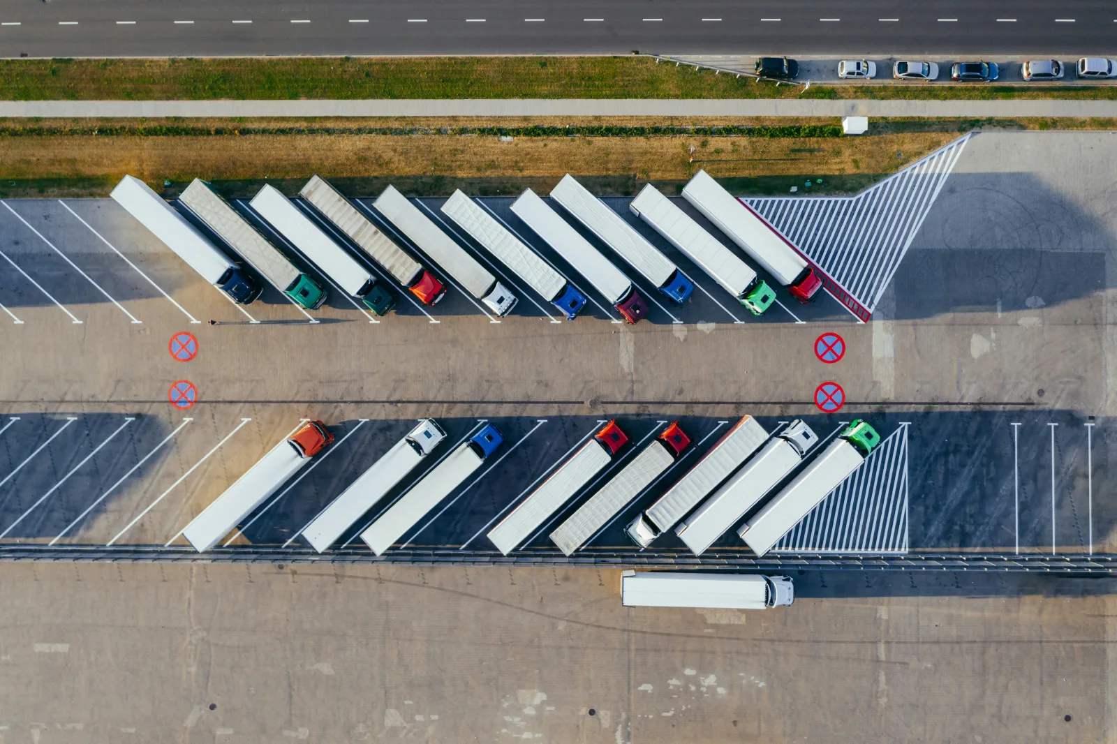 Aerial view of articulated trucks parked in diagonal bays